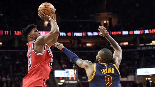 Chicago Bulls forward Jimmy Butler shoots over the defense of Cleveland Cavaliers guard Kyrie Irving (2) during the second half at Quicken Loans Arena. Butler had a triple-double as the Bulls won 117-99.