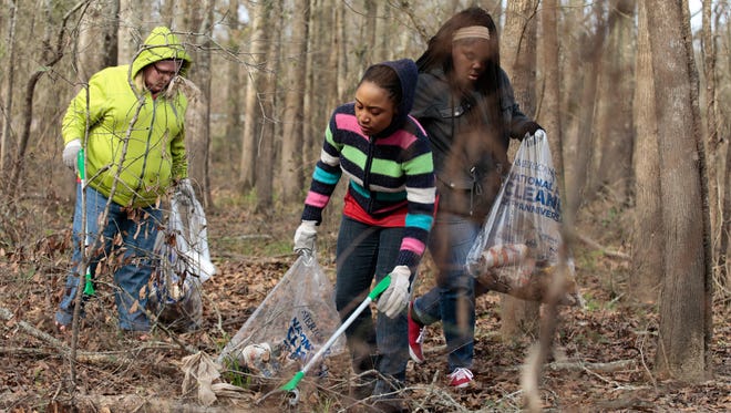 Brentlyn Shelvin, Arieyona Wilson and Brianna Lee, left to right, pick up trash along the banks of the Vermilion during a clean-up project held by Bayou Vermilion District and No Waste Louisiana Saturday, Feb. 4, 2017.