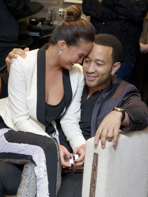 John Legend, right, and his model fiancee, Chrissy Teigen, left attend Sony 4k: Live Beyond Definition on Thursday, Nov. 29, 2012, in Los Angeles. (Photo by Jordan Strauss/Invision for Sony/AP Images)