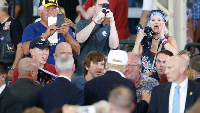 Supporters cheer for Republican presidential candidate Donal Trump as he leaves the stage Saturday, Aug. 27, 2016, during the second annual Roast and Ride at the Iowa State Fairgrounds in Des Moines.