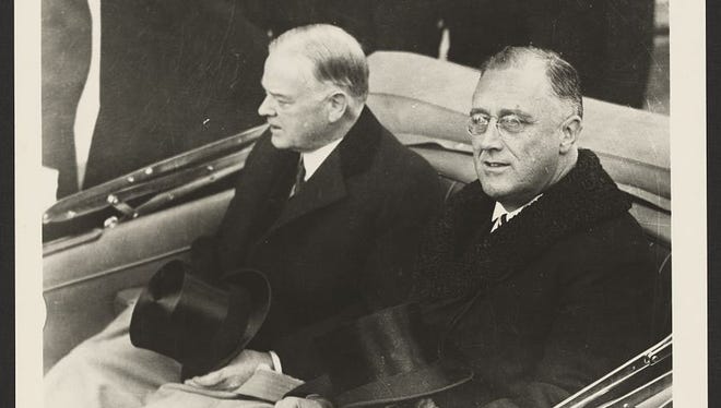 President-elect Franklin Delano Roosevelt, right, and outgoing President Herbert Hoover ride in a convertible en route to the U.S. Capitol for Roosevelt's inauguration on March 4, 1933.