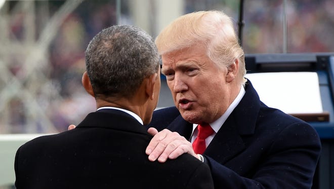 U.S. President Donald Trump speaks with former President Obama during the Presidential Inauguration.