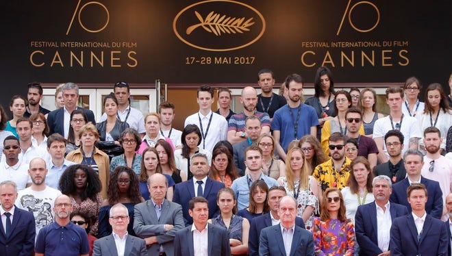Cannes Film Festival staffers and stars hold a minute of silence Tuesday to pay tribute to the victims of the Manchester terror attack.