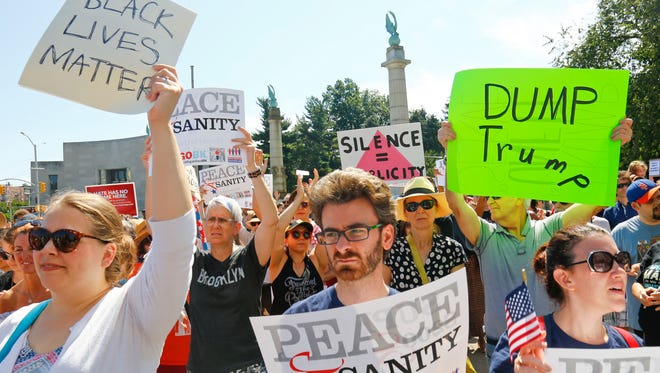 Protesters listen during a "Peace and Sanity" rally on Aug. 13, 2017, in New York, as speakers address white supremacy violence in Charlottesville, Va.