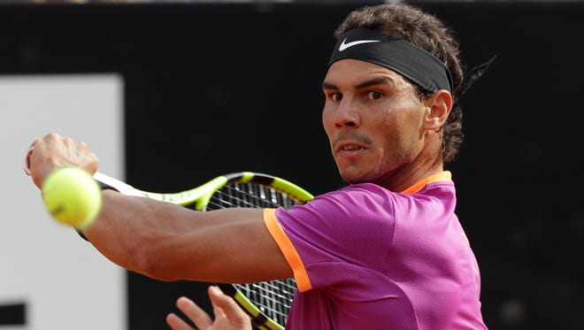 Rafael Nadal of Spain returns the ball to Dominic Thiem of Austria during their match at the Italian Open tennis tournament, in Rome, on May 19.