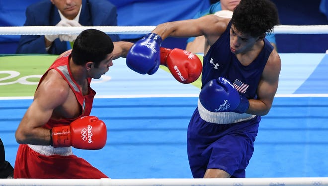 Antonio Vargas of the United States throws a punch against Shakhobidin Zoirov of Uzbekistan in a men's fly preliminary bout at Riocentro - Pavilion 6 during the Rio 2016 Summer Olympic Games.