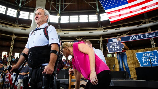 Veteran Billy Woods walks with a special machine during Sen. Joni Ernst's speech during her Roast and Ride event at the Iowa State Fairgrounds on Saturday, August 27, 2016 in Des Moines.