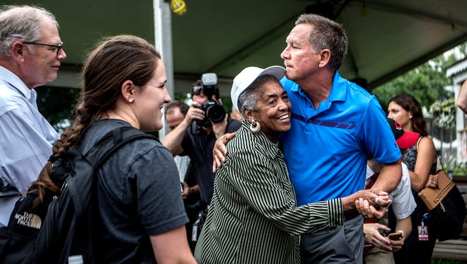 Gov. John Kasich dances with Laura Harvey at the Ohio State Fair during his tour of the grounds Thursday morning.