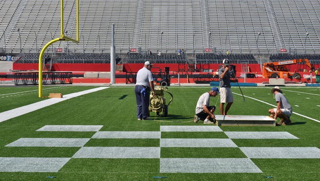 Grounds crew paints the Tennessee end zone prior to the school's game against Virginia Tech at Bristol Motor Speedway.