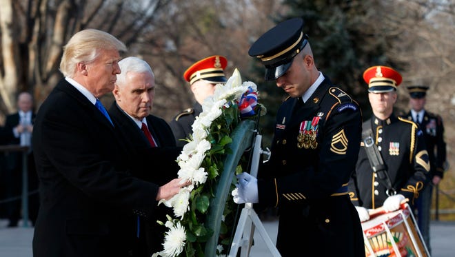 President-elect Donald Trump, accompanied by Vice President-elect Mike Pence places a wreath at the Tomb of the Unknowns, Jan. 19, 2017, at Arlington National Cemetery in Arlington, Va., ahead of Friday's presidential inauguration.