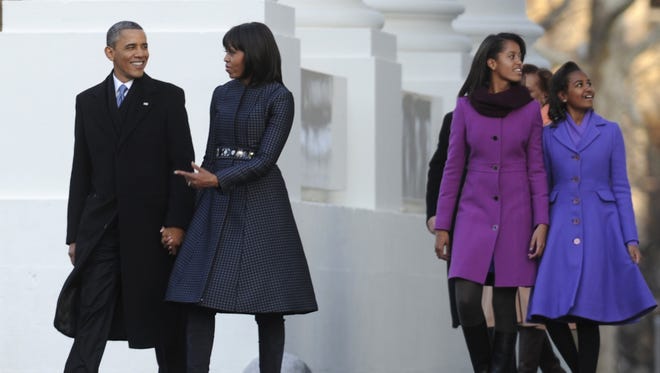 The first family walks to the reviewing stand on Pennsylvania Avenue to watch the parade for Obama's second inauguration on Jan. 21, 2013.