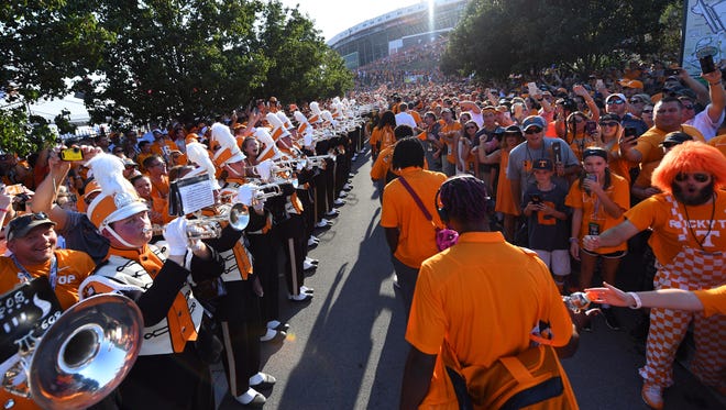 Tennessee players walk through fans during Vol Walk prior to their game against Virginia Tech at Bristol Motor Speedway.