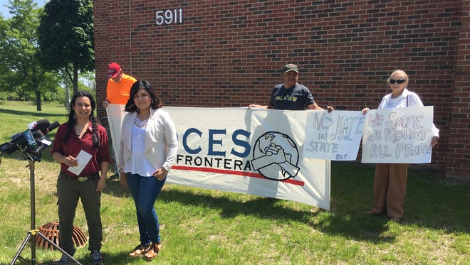 Katherine Torres, front right, stands with workers' and immigrant rights' group Voces de la Frontera outside the Greendale police building Friday before she filed a complaint alleging racial profiling by a police officer.