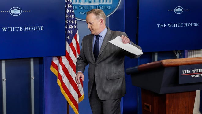 White House press secretary Sean Spicer walks from the podium without taking questions after delivering his first statement in the Brady press briefing room at the White House Saturday.
