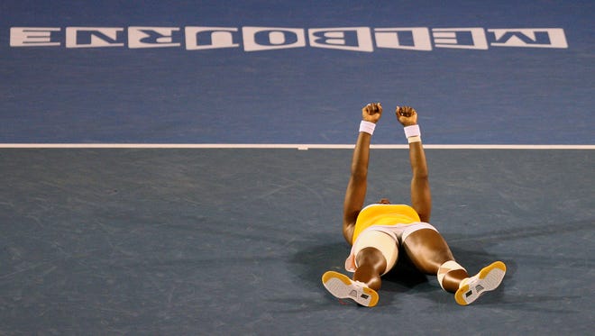 Serena Williams collapses on the court in celebration after winning the 2010 Australian Open women's singles title.