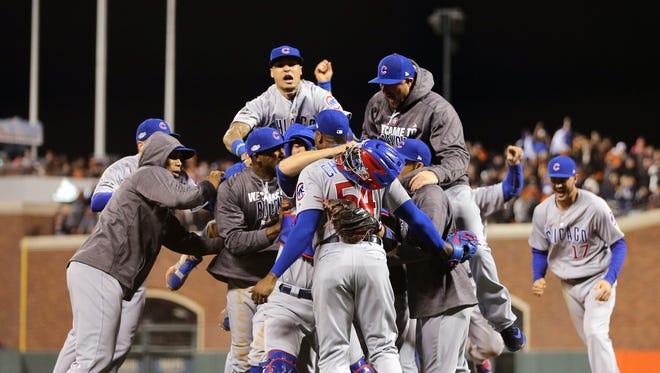 The Cubs celebrate after defeating the Giants in Game 5 to advance to the NLCS.