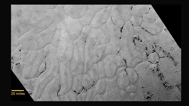 In the center left of Pluto’s vast heart-shaped feature – informally named “Tombaugh Regio” - lies a vast, craterless plain that appears to be no more than 100 million years old, and is possibly still being shaped by geologic processes. This frozen region is north of Pluto’s icy mountains and has been informally named Sputnik Planum (Sputnik Plain), after Earth’s first artificial satellite. The surface appears to be divided into irregularly-shaped segments that are ringed by narrow troughs.