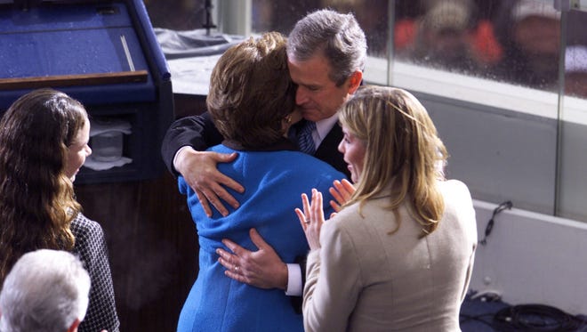 George W. Bush is surrounded by his family as he is sworn in as the 43rd president on Jan. 20, 2001.