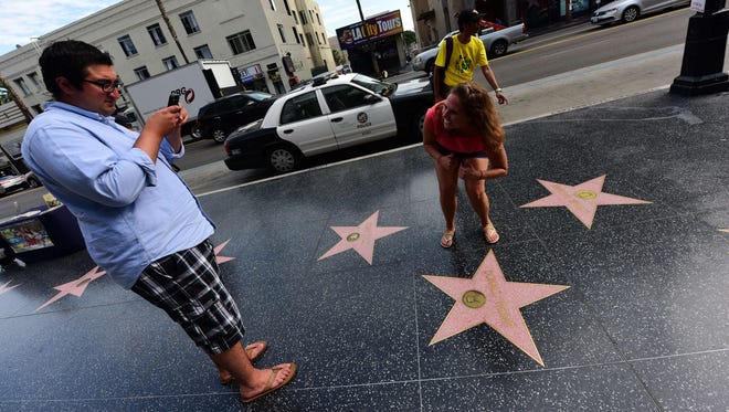 Passersby photograph Donald Trump's star on the Hollywood Walk of Fame on Sept. 10, 2015.
