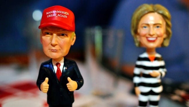 Bobble head figurines of Republican presidential nominee Donald Trump and Democratic presidential nominee Hillary Clinton. The figurines greeted Republican party supporters watching a presidential debate hosted by the Colorado Republican Party at Choppers Sports Grill in Denver, Colorado, on Oct. 9, 2016.