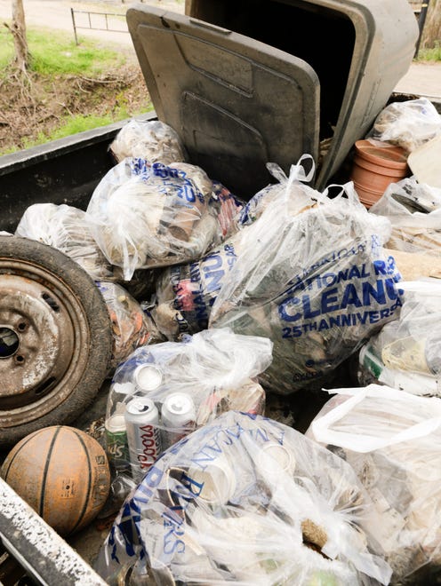 Debris collected from the banks of the Vermilion fills a truck bed during a clean-up project held by Bayou Vermilion District and No Waste Louisiana Saturday, Feb. 4, 2017.