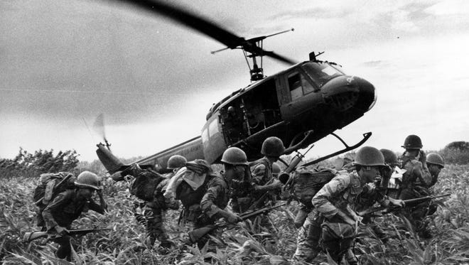 South Vietnamese Marines rush to the point where a descending U.S. Army helicopter will pick them up after a sweep east of the Cambodian town of Prey-Veng in June 1970 during the Vietnam War.