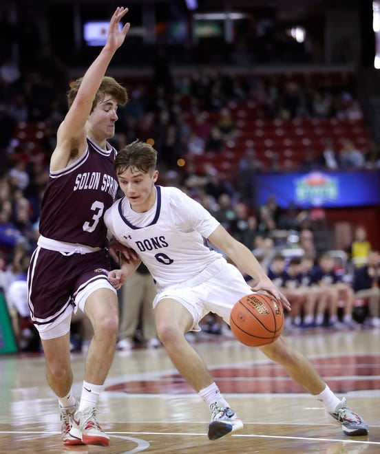 Columbus Catholic High School's Emmitt Konieczny (0) against Solon Springs High School's guard Owen Smith (3) in a Division 5 semifinal game during the WIAA state boys basketball tournament on Friday, March 15, 2024 at the Kohl Center in Madison, Wis.
Wm. Glasheen USA TODAY NETWORK-Wisconsin