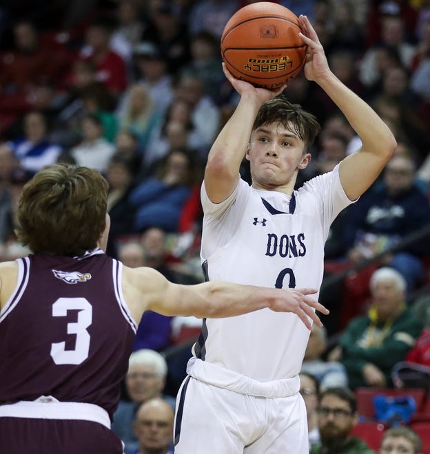 Columbus Catholic High School's Emmitt Konieczny (0) shoots a 3-pointer against Solon Springs High School in a Division 5 semifinal game during the WIAA state boys basketball tournament on Friday, March 15, 2024 at the Kohl Center in Madison, Wis. Columbus Catholic won the game, 78-65.