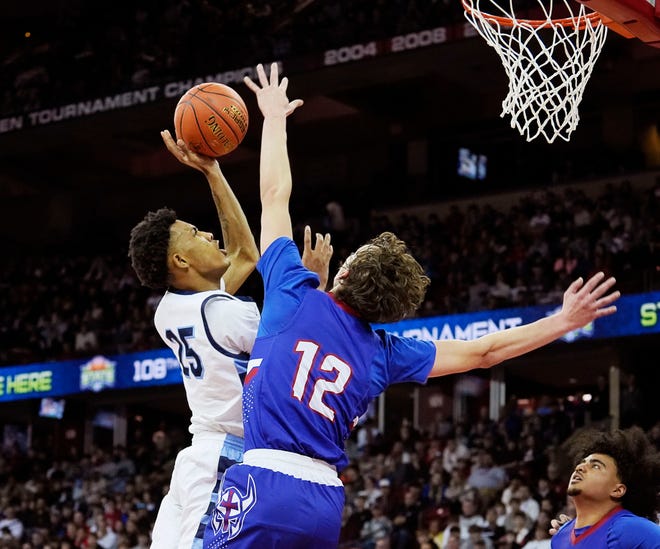 Wisconsin Lutheran's Logan Rindfleisch (12) attempts to block Nicolet's Davion Hannah (25) during the first half of the WIAA Division 2 boys basketball state semifinal game on Friday March 15, 2024 at the Kohl Center in Madison, Wis.