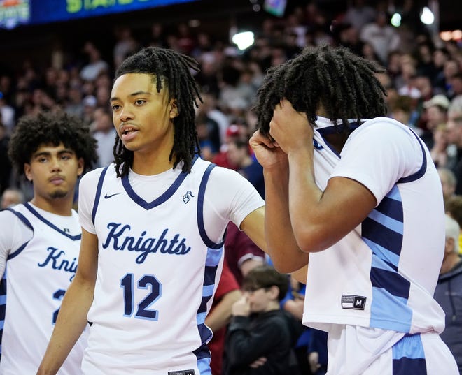Nicolet's Jordan Lovelace (12) comforts David Bolden (3) after their loss to Wisconsin Lutheran in the WIAA Division 2 boys basketball state semifinal game on Friday March 15, 2024 at the Kohl Center in Madison, Wis.