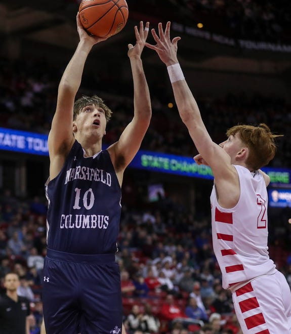 Columbus Catholic High School's Lucas Kreklau (10) puts up a shot over Abundant Life Christian School's Jacob Koon (2) in the Division 5 state championship game during the WIAA state boys basketball tournament on Saturday, March 16, 2024 at the Kohl Center in Madison, Wis. Columbus Catholic won the game, 81-75.