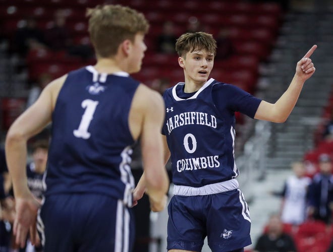 Columbus Catholic High School's Emmitt Konieczny (0) points to a teammate after a made basket against Abundant Life Christian School in the Division 5 state championship game during the WIAA state boys basketball tournament on Saturday, March 16, 2024 at the Kohl Center in Madison, Wis. Columbus Catholic won the game, 81-75.