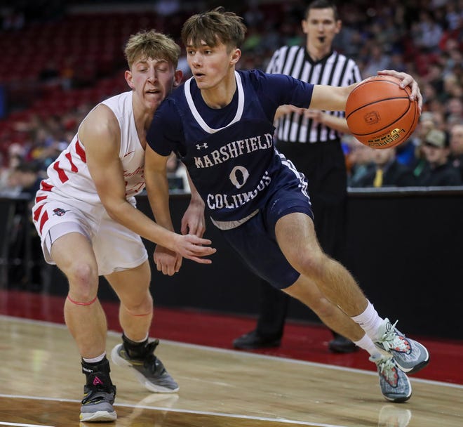 Columbus Catholic High School's Emmitt Konieczny (0) drives past Abundant Life Christian School's Noah Wallace (14) in the Division 5 state championship game during the WIAA state boys basketball tournament on Saturday, March 16, 2024 at the Kohl Center in Madison, Wis. Columbus Catholic won the game, 81-75.