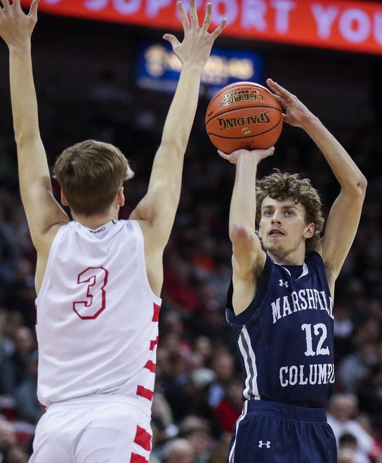 Columbus Catholic High School's Charlie Moore (12) shoots a 3-pointer against Abundant Life Christian School in the Division 5 state championship game during the WIAA state boys basketball tournament on Saturday, March 16, 2024 at the Kohl Center in Madison, Wis. Columbus Catholic won the game, 81-75.