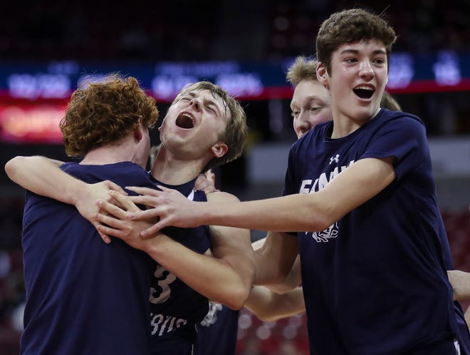Columbus Catholic High School's Blake Jakobi (center) celebrates with his teammates after defeating Abundant Life Christian School in the Division 5 state championship game during the WIAA state boys basketball tournament on Saturday, March 16, 2024 at the Kohl Center in Madison, Wis. Columbus Catholic won the game, 81-75.
