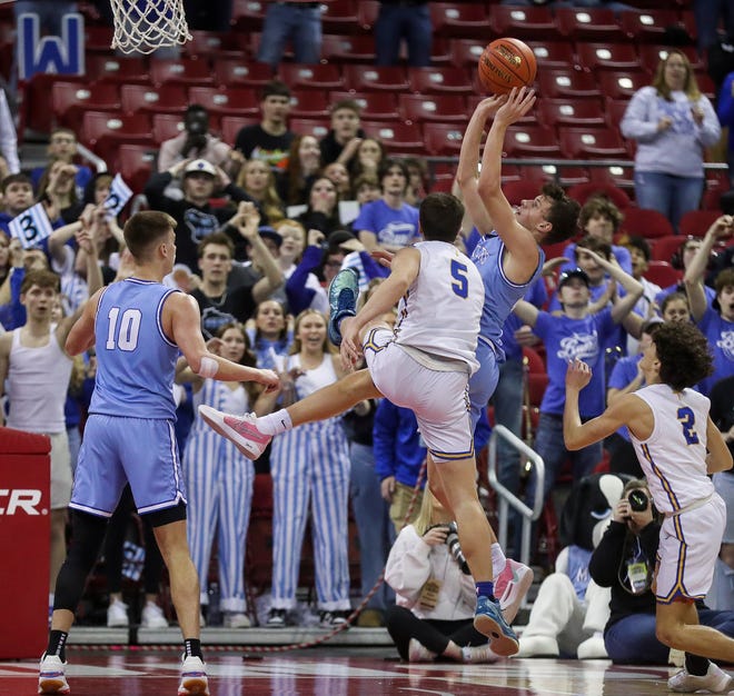 Mineral Point High School’s Drew Ashliman (21) scores a basket on a putback against Kenosha St. Joseph in the Division 4 state championship game during the WIAA state boys basketball tournament on Saturday, March 16, 2024 at the Kohl Center in Madison, Wis. Mineral Point won the game, 65-64, on a putback basket with 1.4 seconds remaining in the game.