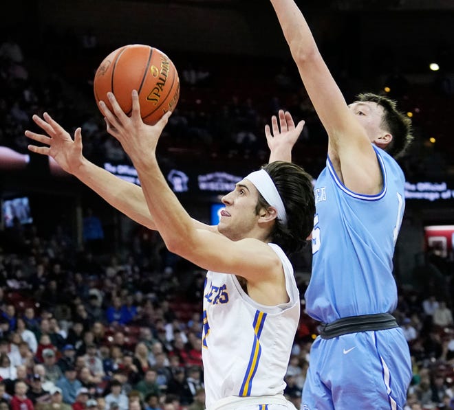 Kenosha St. Joseph's Eric Kenesie (3) drives up to the basket to score as Mineral Point's Brady Radtke (15) attempts to block him during the first half of the WIAA Division 4 boys basketball state championship game on Saturday March 16, 2024 at the Kohl Center in Madison, Wis.