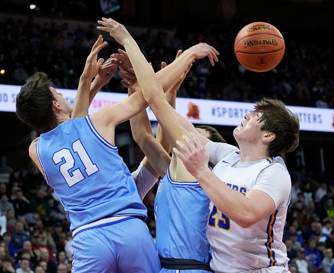 Mineral Point's Drew Aschliman (21), Mineral Point's Brady Radtke (15) and Kenosha St. Joseph's Dominic Santarelli (23) attempt to gain possession of the rebound during the first half of the WIAA Division 4 boys basketball state championship game on Saturday March 16, 2024 at the Kohl Center in Madison, Wis.