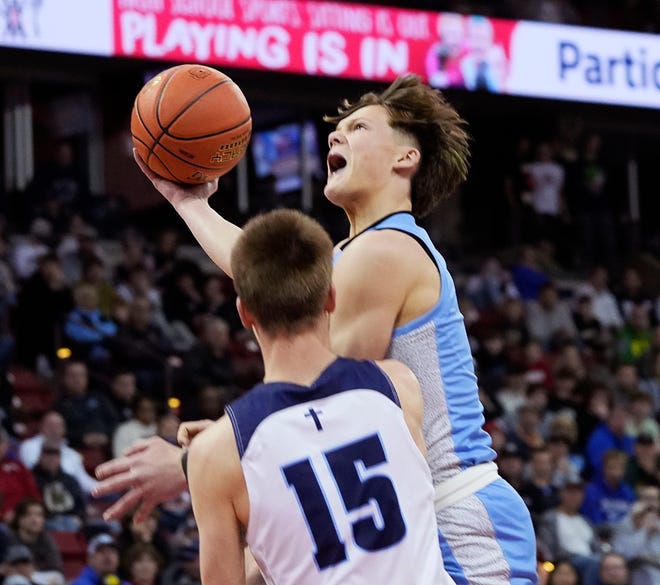 St. Thomas More's Kyle Alivo (1) attempts to score as Lakeside Lutheran's Kooper Mlsna (15) guards him during the first half of the WIAA Division 3 boys basketball state championship game on Saturday March 16, 2024 at the Kohl Center in Madison, Wis.