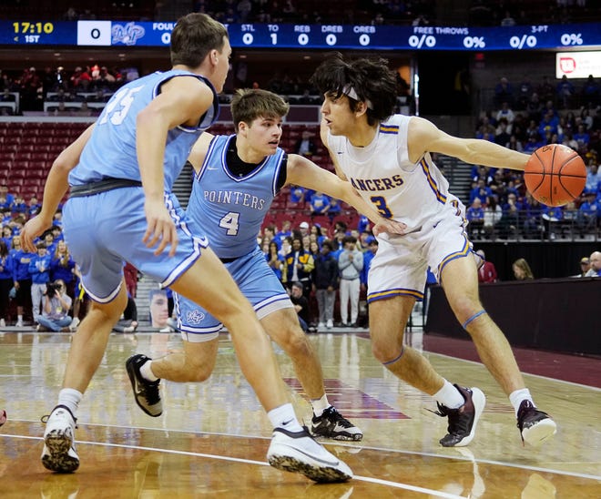 Mineral Point's Brady Radtke (15) and Mineral Point's Bryce Vamstad (4) guard Kenosha St. Joseph's Eric Kenesie (3) during the first half of the WIAA Division 4 boys basketball state championship game on Saturday March 16, 2024 at the Kohl Center in Madison, Wis.