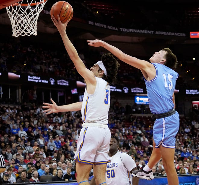 Kenosha St. Joseph's Eric Kenesie (3) scores as Mineral Point's Brady Radtke (15) attempted to block him during the first half of the WIAA Division 4 boys basketball state championship game on Saturday March 16, 2024 at the Kohl Center in Madison, Wis.