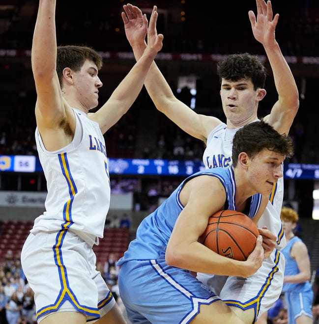 Kenosha St. Joseph's Tommy Santarelli (5) and Lowell Werlinger (15) guard Mineral Point's Drew Aschliman (21) during the second half of the WIAA Division 4 boys basketball state championship game on Saturday March 16, 2024 at the Kohl Center in Madison, Wis.