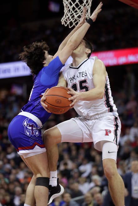 Wisconsin Lutheran High School's Isaiah Mellock (4) against Pewaukee High School's Nick Janowski (25) in a Division 2 championship game during the WIAA state boys basketball tournament on Saturday, March 16, 2024 at the Kohl Center in Madison, Wis.
Wm. Glasheen USA TODAY NETWORK-Wisconsin