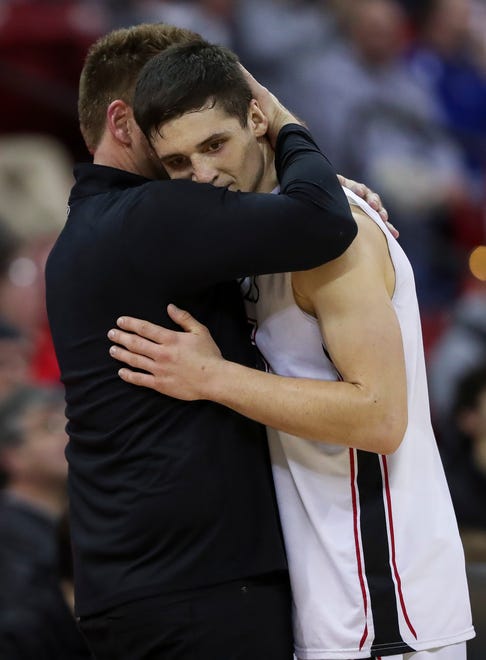 Pewaukee High School's Nick Janowski (25) hugs head coach David Burkemper as he checks out of the game for the final time against Wisconsin Lutheran High School in the Division 2 state championship game during the WIAA state boys basketball tournament on Saturday, March 16, 2024 at the Kohl Center in Madison, Wis. Wisconsin Lutheran won the game, 83-62.
Tork Mason/USA TODAY NETWORK-Wisconsin