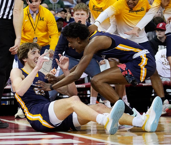 Marquette's Nolan Minessale (23) and Marquette's Jeremiah Johnson (10) celebrate as Arrowhead's Jace Gilbert (4) is fouled out during the second half of the WIAA Division 1 boys basketball state championship game on Saturday March 16, 2024 at the Kohl Center in Madison, Wis.