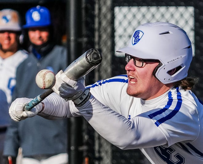 Oak Creek's Reece Doyle (24) lays down a successful bunt during the game at home against Racine Horlick, Friday, April 19, 2024.