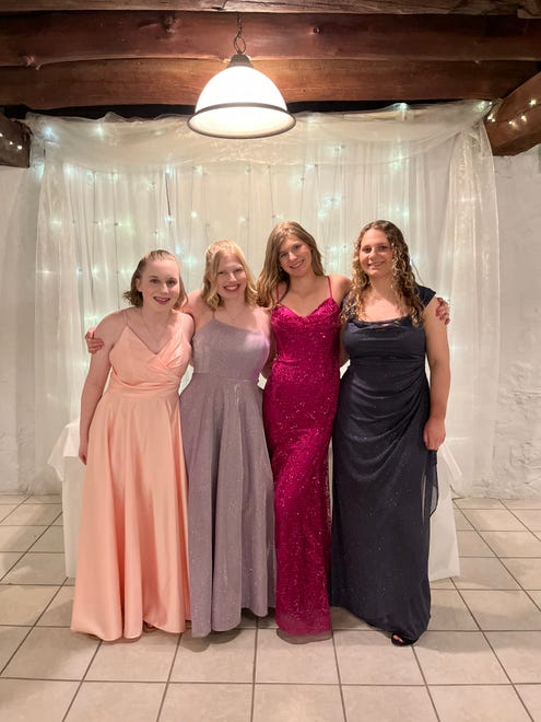 Josie Hart (front left), Abbie Hart, Breanna Borel and Myrinda Springer pose for a photo before heading to Hortonville High School's prom on Saturday, April 13, 2024, at the Homestead Meadows Farm in Appleton.
