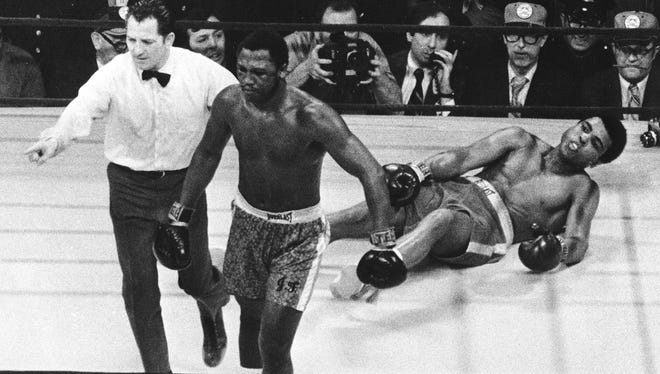Joe Frazier is directed to the ropes by referee Arthur Marcante after knocking down Ali during the 15th round of the title bout at Madison Square Garden on March 8, 1971.  Frazier won the bout by decision.