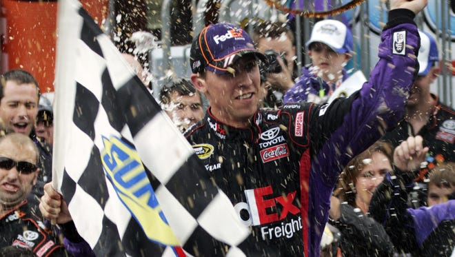 Denny Hamlin celebrates winning the Tums 500 Sprint Cup race at Martinsville Speedway on Oct. 25, 2009.Hamlin guaranteed that he would win this race after he came in second at the spring race.