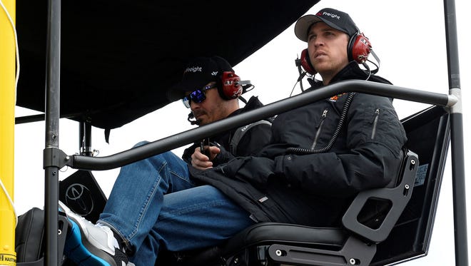 Denny Hamlin, watching the STP 400 at Kansas Speedway from his pit box, missed four full races after fracturing a vertebrae in his back at Fontana, Calif.